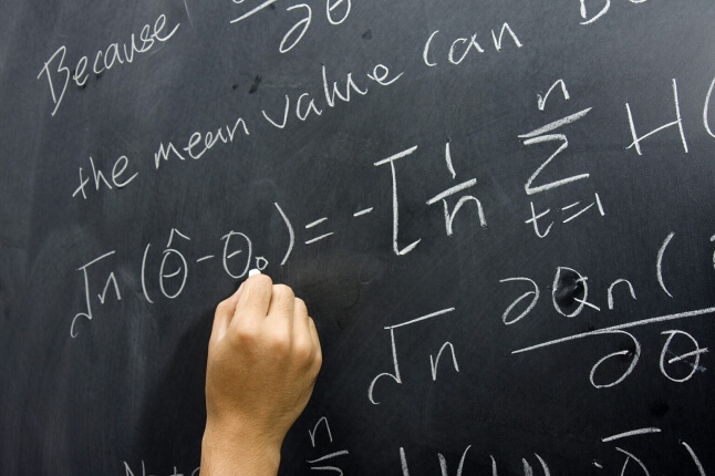 image of hand writing on blackboard