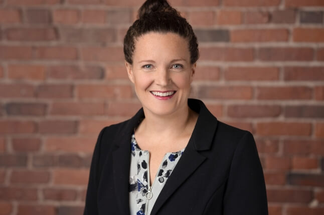Image of Harvard graduate Emily Parfit in front of a brick wall